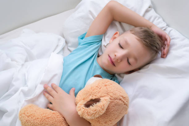 istock boy sleeping sweetly hugging a toy 1370660214