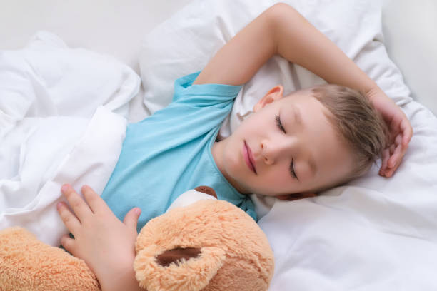 istock boy sleeping sweetly hugging a toy 1370660748