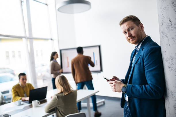 istock Young male businessman typing message on smart phone 1370660770