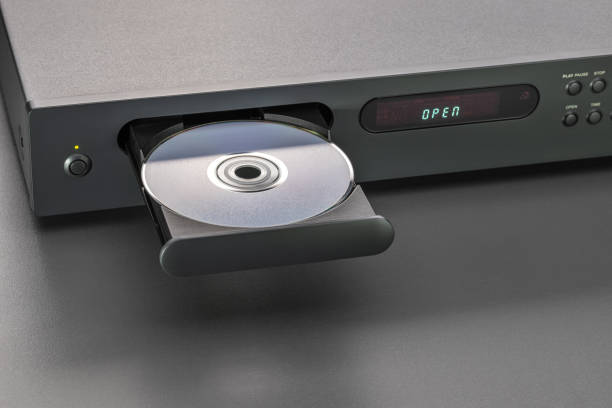 Disc on an open CD player tray, studio shot, close-up. Equipment for listening to your favorite music, recreation, leisure, entertainment. open cd player stock pictures, royalty-free photos & images