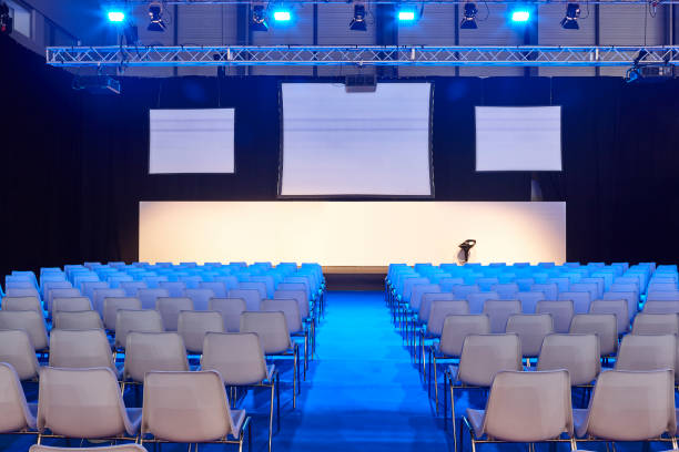 istock Conference room with video projectors, screens and platform. Congress hall 1370661057
