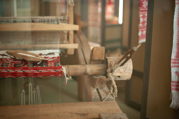 istock Old loom, spinning machine, rows of white and colored cotton threads 1370661382