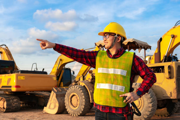 istock asian technician civil engineer talk with team by walkie talkie and point at inspection survey point for transport construction work project with excavator on engineering site background 1370661586