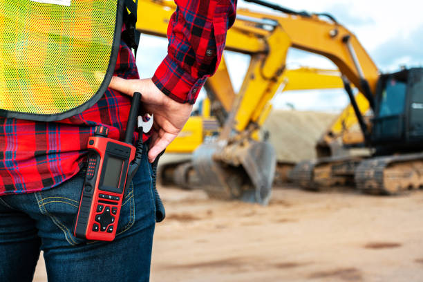 istock asian technician civil engineer talk with team by walkie talkie and point at inspection survey point for transport construction work project with excavator on engineering site background 1370661602