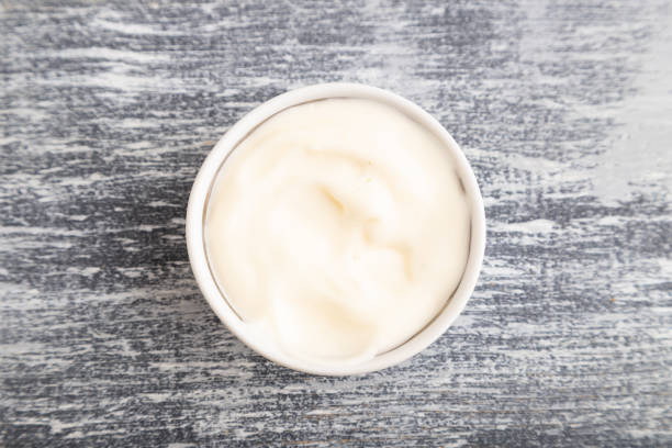 istock ceramic sauce bowl with, mayonnaise on a gray. Top view, copy space. 1370662322