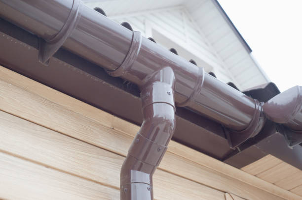 istock Gutter with downpipe on the roof of a house. 1370662427