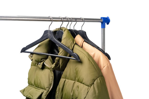 istock Clothes hang on clothing rack over white background. 1370662769
