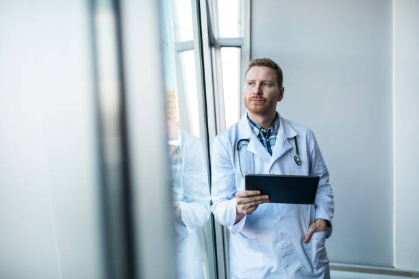istock Young worried doctor looking at the results 1370662951