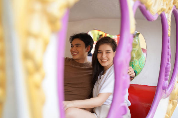istock activity of young couple at amusement park. 1370664093