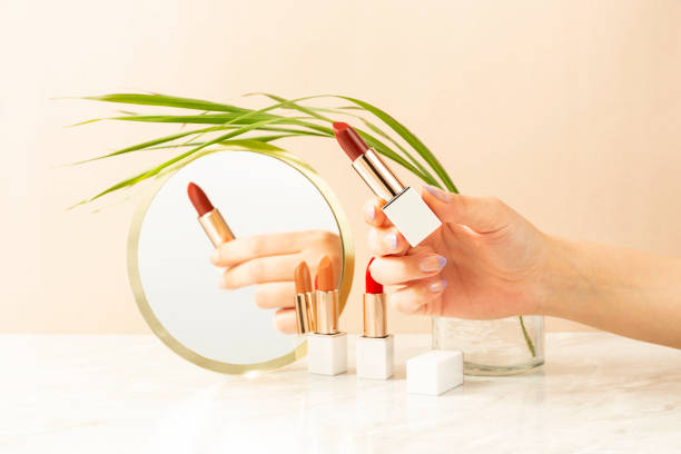 istock woman is holding lipstick in the mirror 1370665081