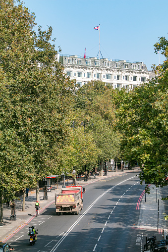 Savoy Hotel on The Strand in City of Westminster, London. Cars and people in traffic can be seen on the Victoria Embankment.