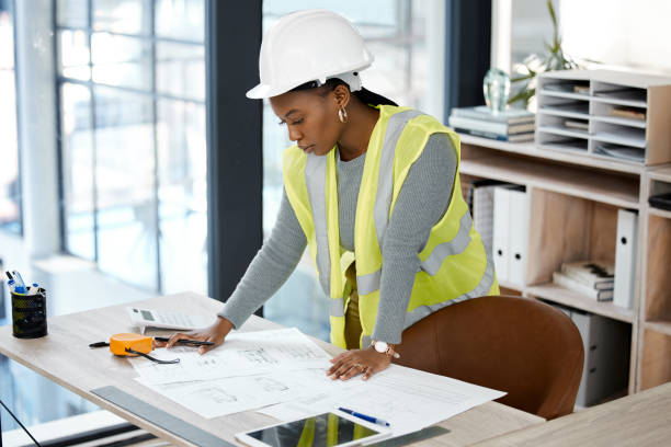 Shot of a female engineer drawing up blueprints