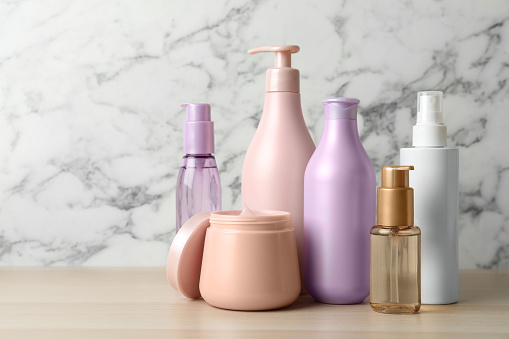 Different hair care products on wooden table