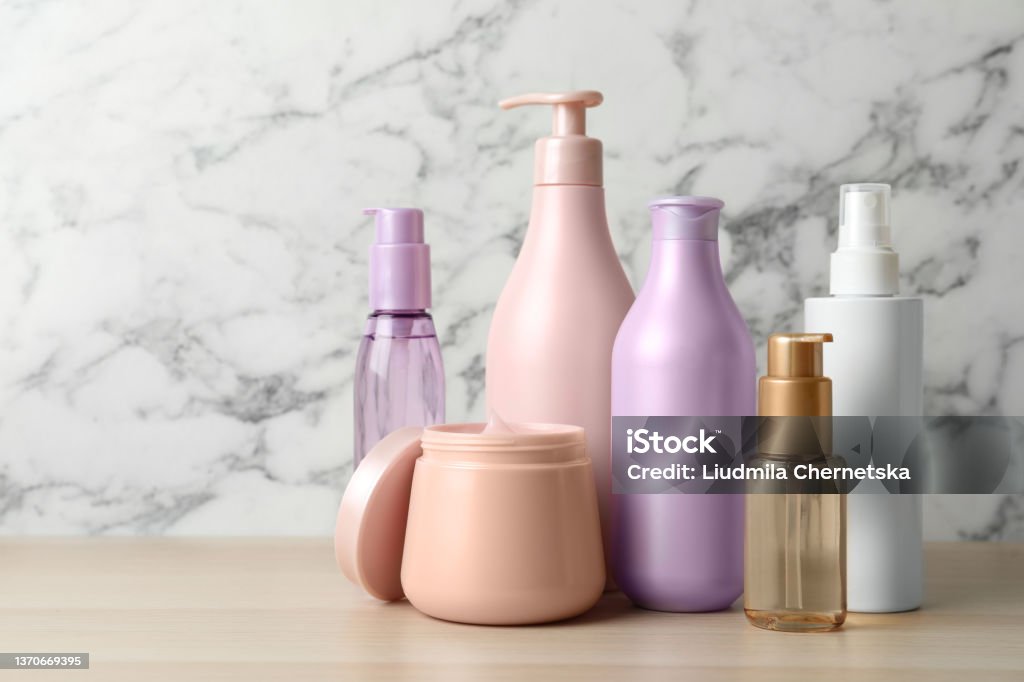 Different hair care products on wooden table Merchandise Stock Photo