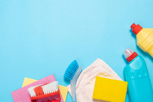 istock bottles and sprays cleaning agent brushes sponges rags on a colored background on the side. Professional cleaning products, general cleaning. Household chemicals 1370669524