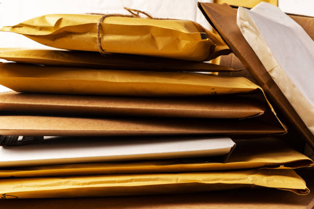Close-Up Of Gifts With Mails On Table
