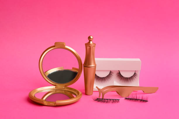 istock Magnetic eyelashes and accessories on crimson background 1370670903