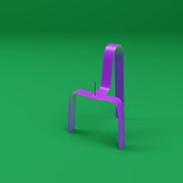 A pushpin on the black plastic chair. Copy space.