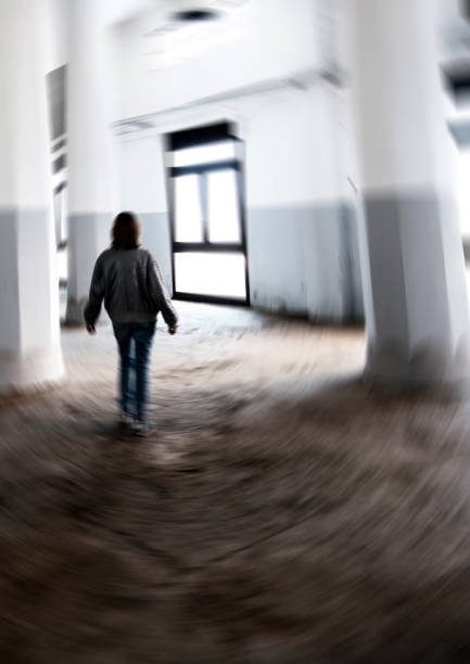 Woman walking in abandoned silo.