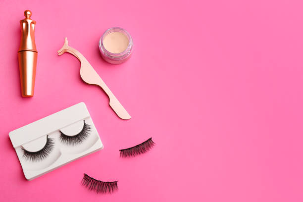 istock Flat lay composition with magnetic eyelashes and accessories on crimson background. Space for text 1370671473