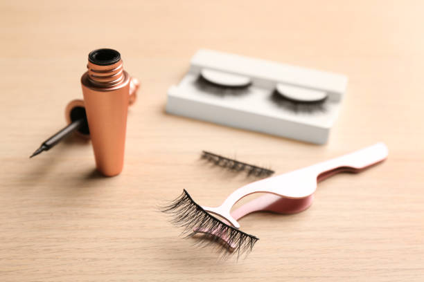 istock Magnetic eyelashes and accessories on wooden table 1370672129