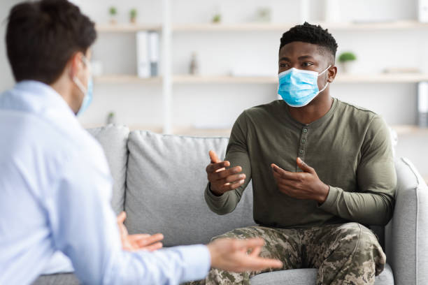 istock Black soldier in face mask visiting psychologist while pandemic 1370672507