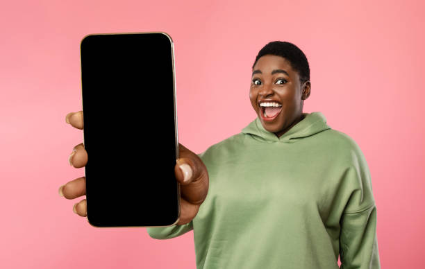 istock Excited overweight black lady showing smartphone with blank screen 1370672587