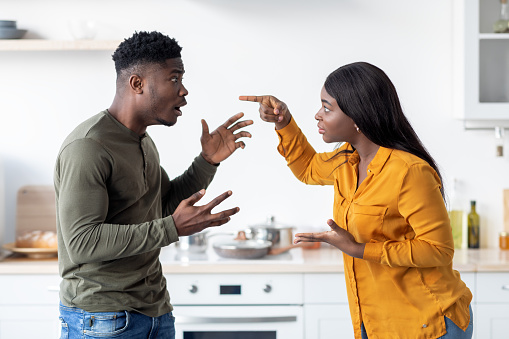 Lovers Fight. Portrait Of Andry Black Couple Emotionally Arguing In Kitchen, African American Spouses Screaming At Each Other, Suffering Problems In Relationship Or Marital Crisis, Side View