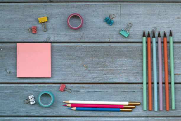 istock Office scool supplies on blue wood desk. 1370673138