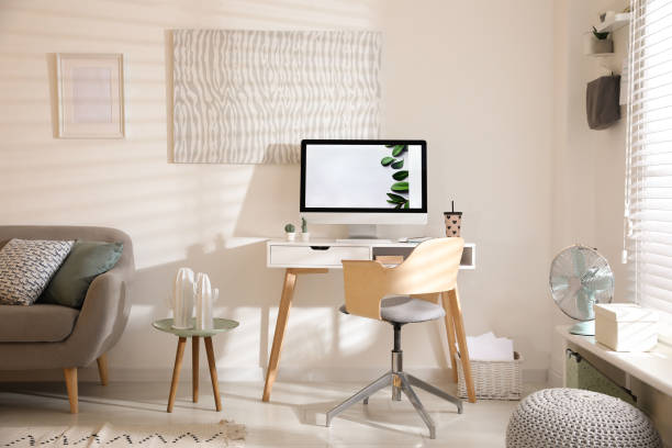Comfortable office chair near desk with modern computer indoors