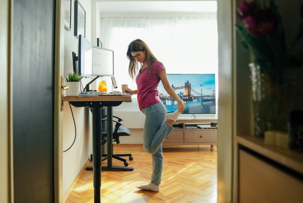 istock Young woman working at standing desk 1370674668