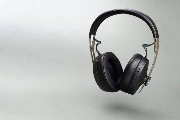 istock Levitating wireless headphones on a gray background. Copy space for text 1370675252