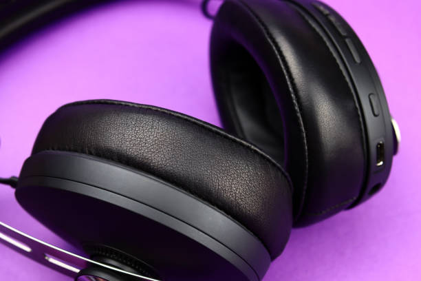 istock Full-size wireless headphones close-up on a purple background 1370675268