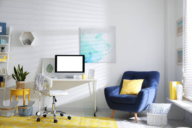 istock Comfortable office chair near desk with modern computer indoors 1370675352