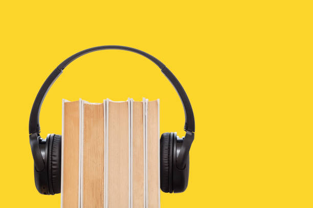 istock Headphones on books on yellow background 1370675543