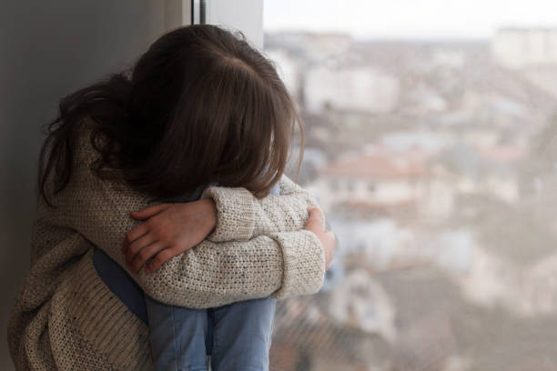 istock Upset Sad Stressed Depressed Teenager at window 1370676315