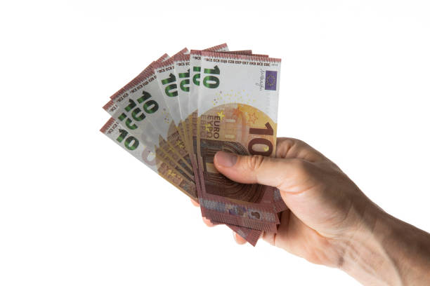 Human hand is holding ten euro banknote on white background