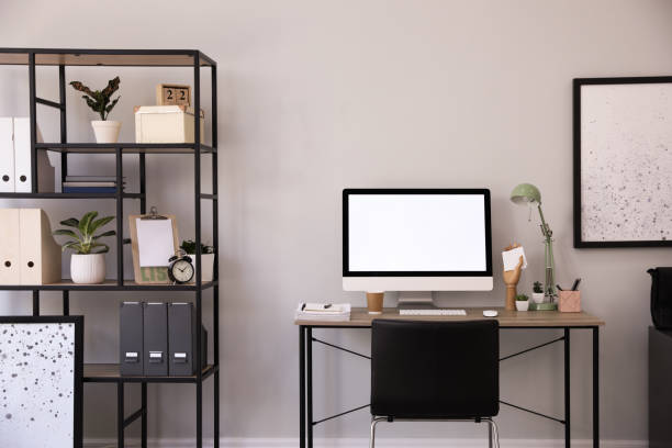 istock Comfortable office chair near desk with modern computer indoors 1370677538