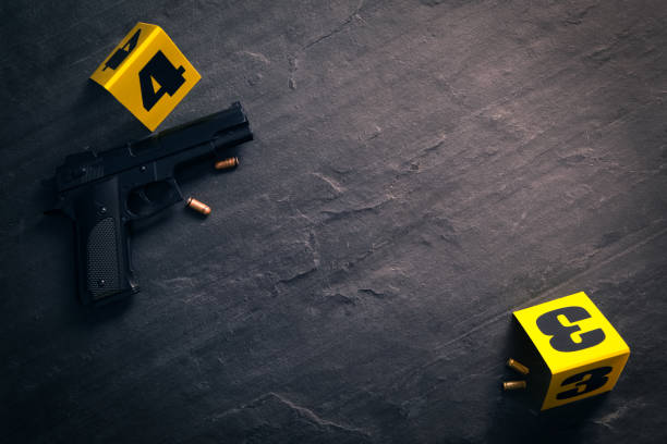 Bullets, gun and crime scene markers on black slate background, flat lay. Space for text Bullets, gun and crime scene markers on black slate background, flat lay. Space for text gun mafia handgun bullet stock pictures, royalty-free photos & images
