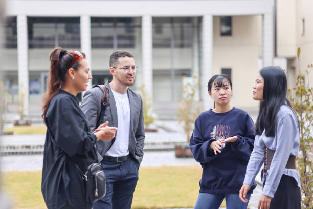 istock Graduate students enjoying talk at college campus 1370678344