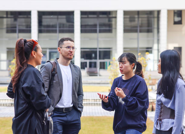 istock Graduate students enjoying talk at college campus 1370678395