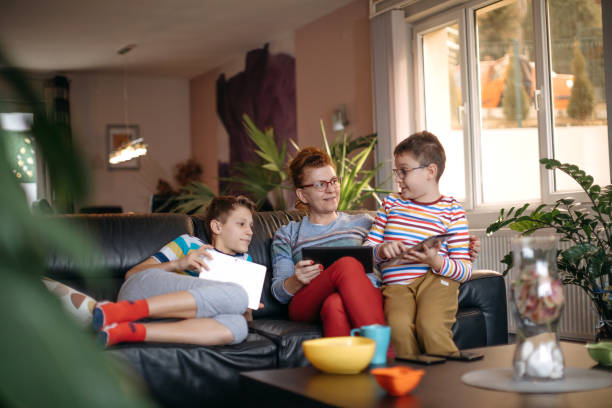 istock Mother with two kids at home 1370678397