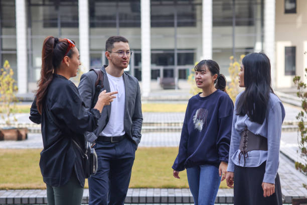 istock Graduate students enjoying talk at college campus 1370678537