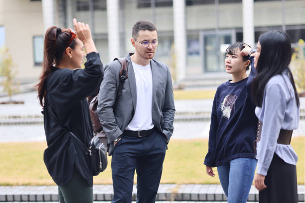 istock Graduate students enjoying talk at college campus 1370678623