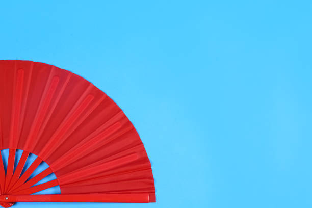 istock Red hand fan on light blue background, top view. Space for text 1370678724