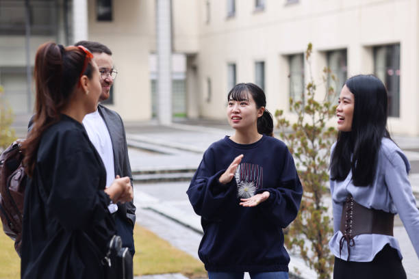 istock Graduate students enjoying talk at college campus 1370678779