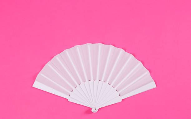 istock White hand fan on pink background, top view 1370679177
