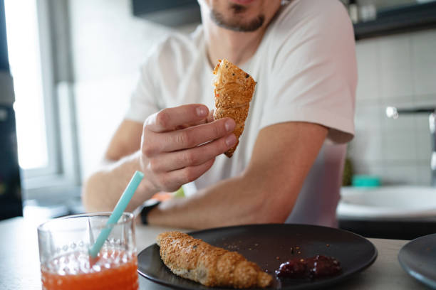 istock Unrecognizable man eating the pastry for breakfast 1370681111