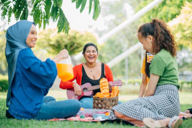 istock Female friend doing picnic together. 1370682592