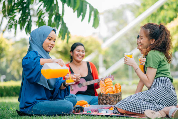 istock Friends enjoying picnic outing. 1370682612